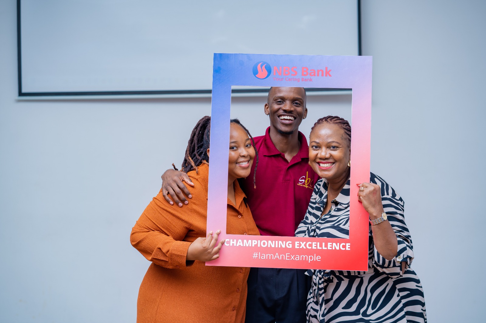 Faith Mabu Nteta with colleagues in a framed group portrait