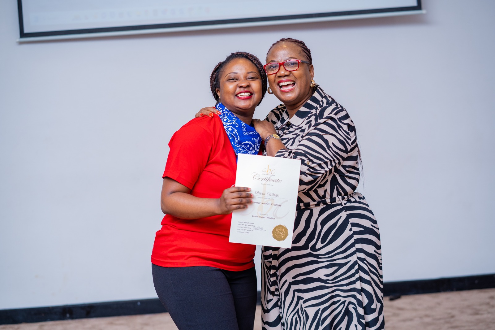 Faith Mabu Nteta presenting a certificate during a team event