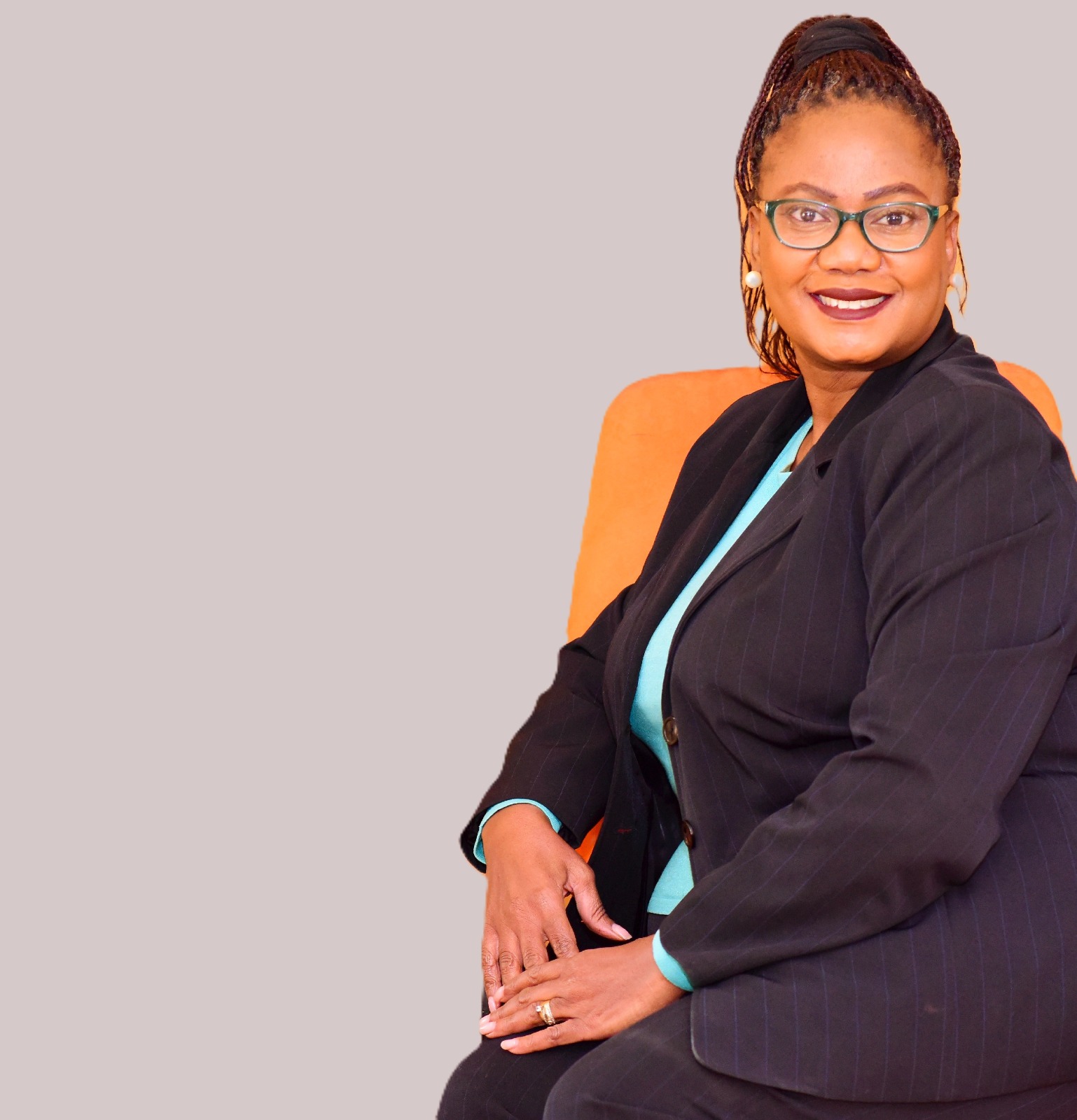 Faith Mabu Nteta seated in a navy suit