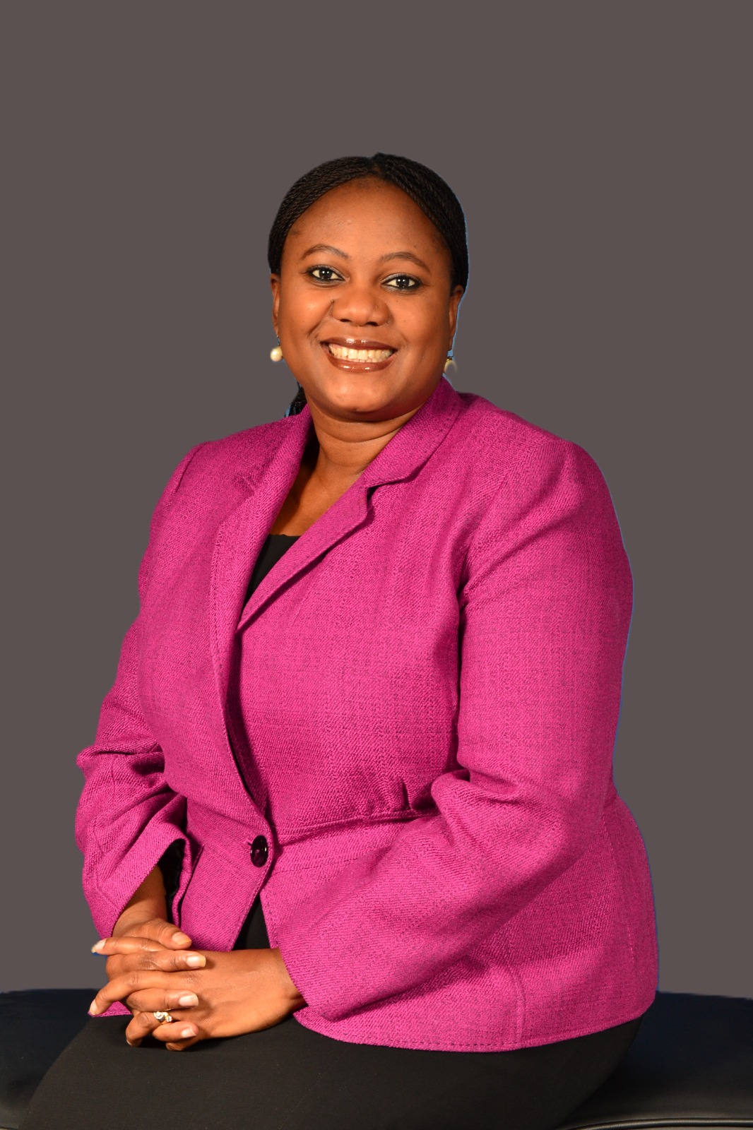 Faith Mabu Nteta seated in a pink blazer